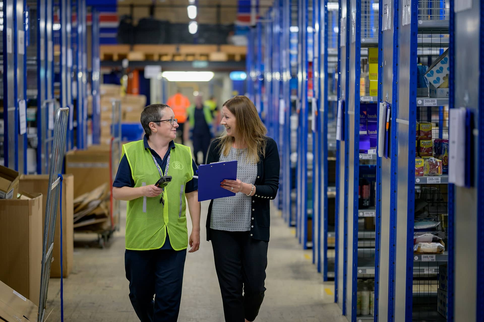 Warehouse employees walking in an aisle